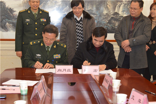 校长梁宏和解放军第一八一医院院长向月应在合作文本上签字，标志着双方共建健康管理学院正式启动