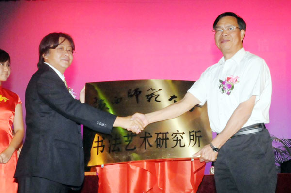 钟瑞添副校长（右）为美术学院新成立的“广西师范大学书法艺术研究所”授匾。